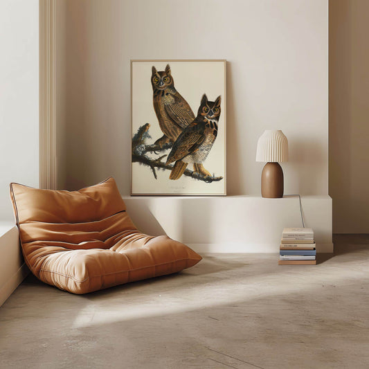 Modern living room with brown leather chair, framed artwork of owls, and decorative lamp.