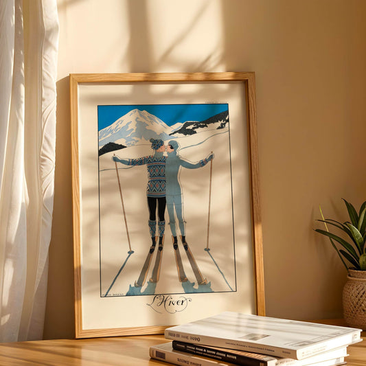 Framed artwork of a skier against a mountain backdrop on a shelf with books and a plant.