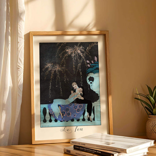 Framed artwork on a table with books and a plant