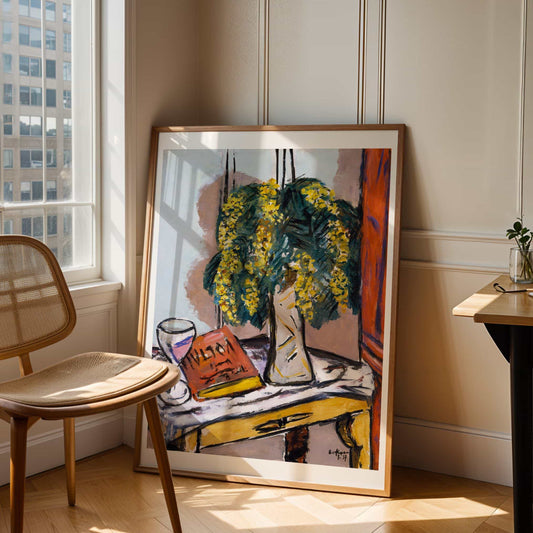 Framed abstract painting on a wall with a chair and table in the foreground