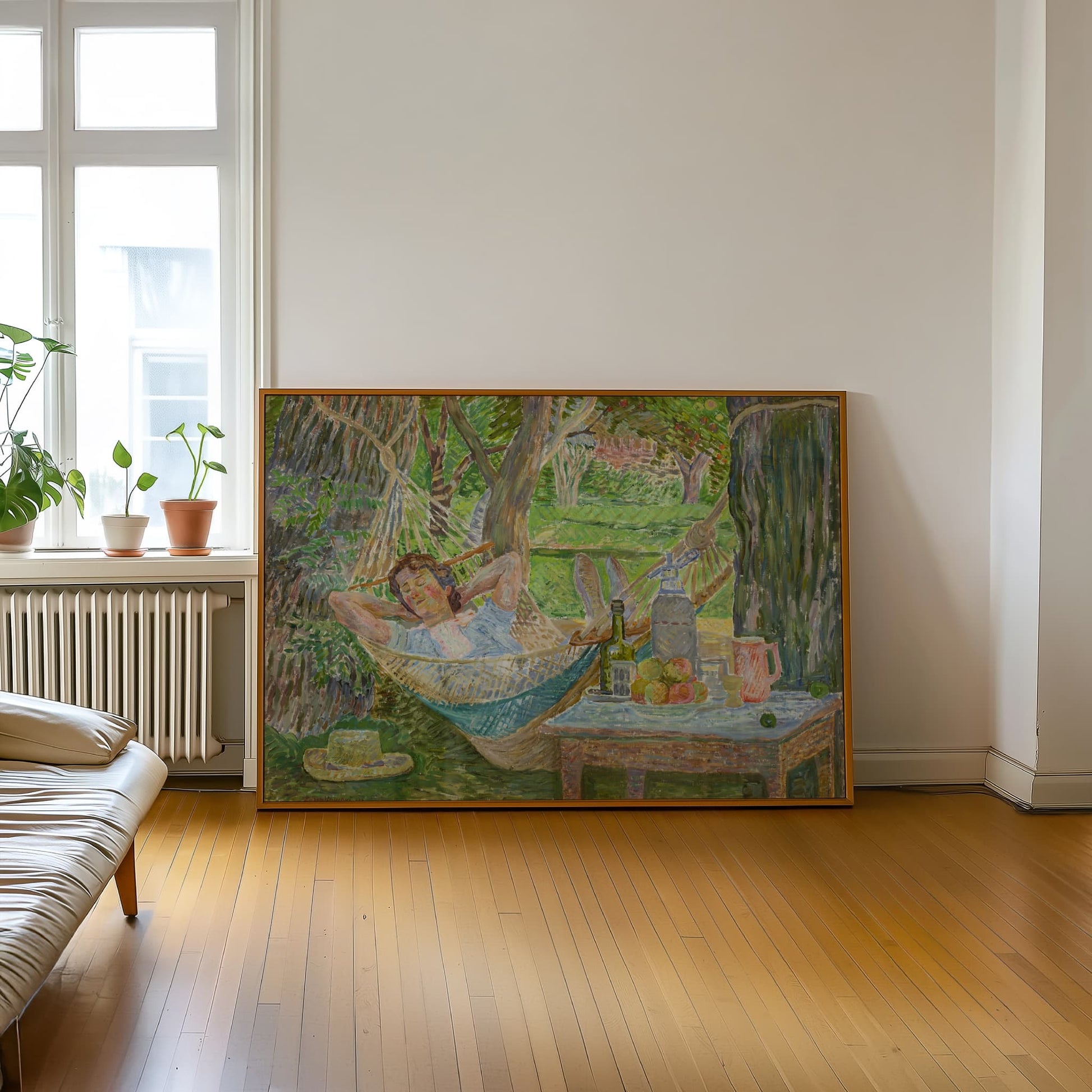 Framed artwork of a woman in a hammock on a wall in a room with wooden floor and window.