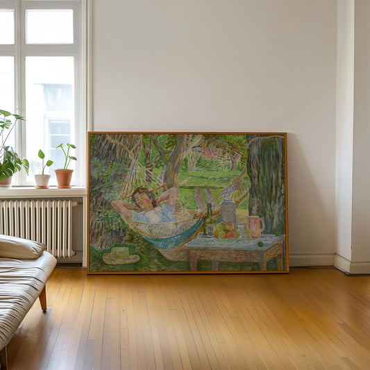 Framed artwork of a woman in a hammock on a wall in a room with wooden floor and window.
