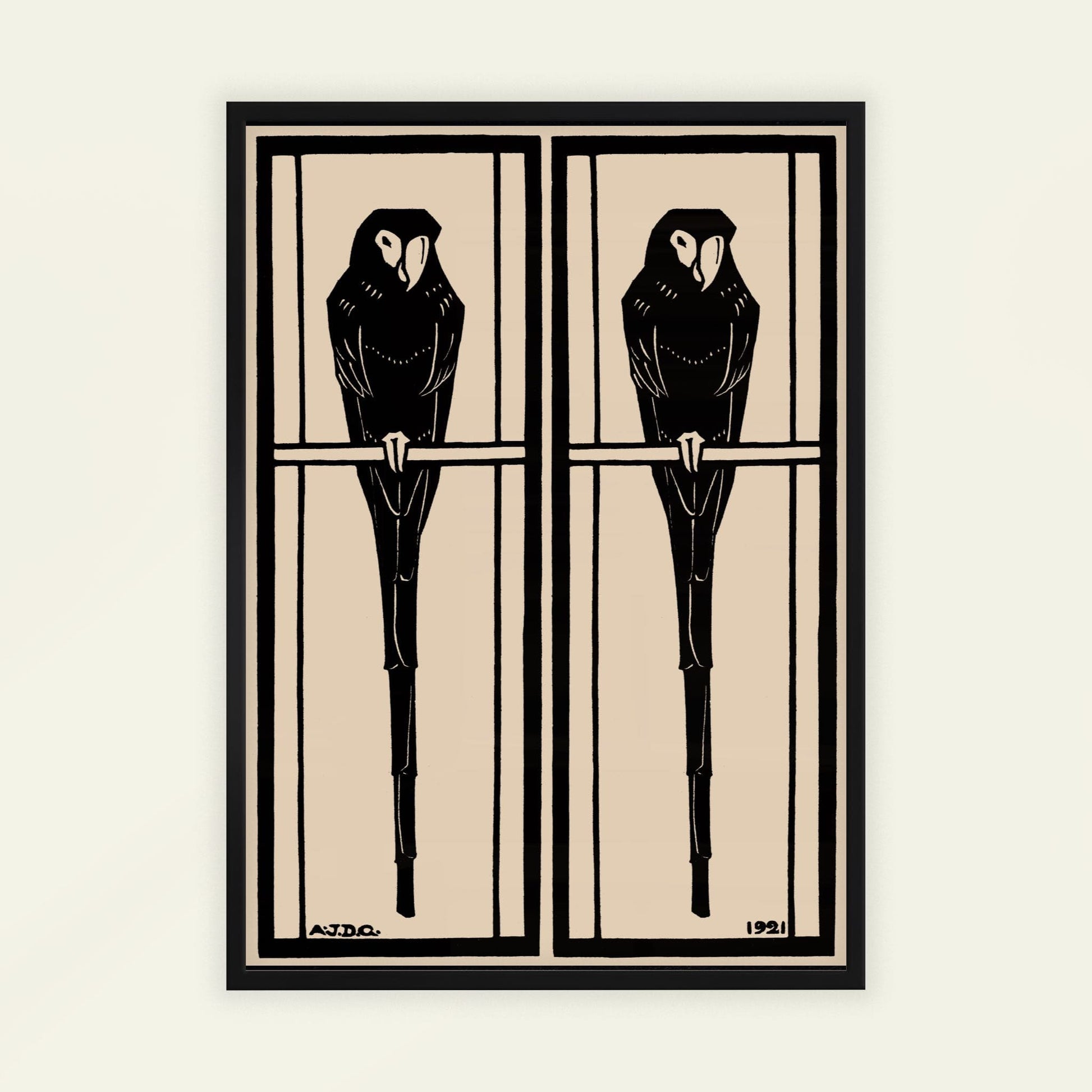 Framed artwork of two black birds on a branch against a beige background