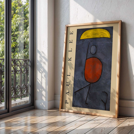 With an Umbrella by Paul Klee | With artist's name. Framed abstract artwork by Paul Klee on a wooden floor with a window in the background